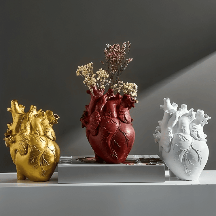 Gold, red, and white PLTNRTZ® Amor Heart Vases displayed together, showcasing the available color options in a striking arrangement.